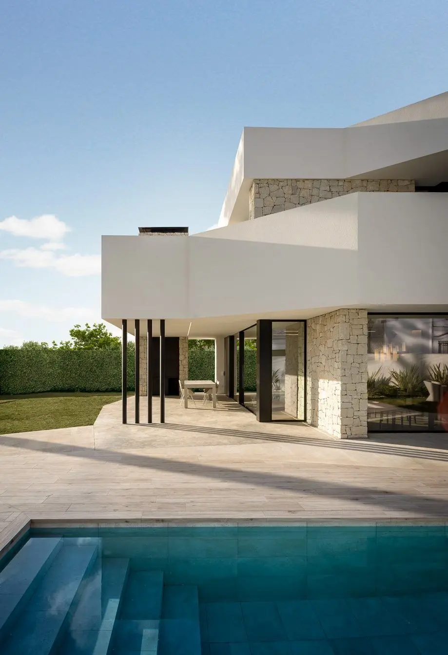 Terrace and pool of a new-build villa with stone cladding
